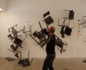 A man hurls chairs at a wall for 12 minutes in what seems to be a holy-rage attack. This expressive performance-for-camera fluctuates between satisfaction and futility while simultaneously creating compositions of destructive beauty.nnThe work is part of Haaretz Art Collection, Tel Aviv, and The Angel Collection of Contemporary Art, Tel Aviv.nn