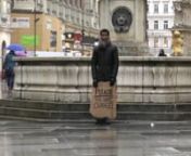 Rahman Hak-Hagir, Alfie Nze - FREE CHANGE (2016)nPublic Performance; Video Documentation / 24 mins. / HDn3rd Feb. 2016 / Stefansplatz, Kärntnerstraße / Vienna nn“No one has ever become poor by giving.” n― Anne Frank, diary of Anne Frank: the play nnConcept, Camerafocussing on the conflicting priorities between individual and social environment. His performances, photographies and films are displayed in international museums like MONA Detroit (USA) and MUAB Ruden (Austria) as much as in