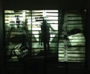 Video for the installation In Transit, projected over a wood crate or pallet wall.nn