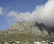 Time lapse of Table Mountain, Cape Town. This time lapse video of Table Mountain, Cape Town, South Africa, was taken from beautiful Camps Bay. The main feature of the video is witnessing the phenomenon of the orographic clouds which appear to over over the mountain and is known as the &#39;Table Cloth&#39;. This occurs because the cold Atlantic air meets the warm Indian Ocean air and forms the clouds with have the appearance of constantly moving over the mountain top.
