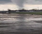 A massive tornado tore through the city of Lincoln, Nebraska, USA, causing widespread destruction and panic. The tornado&#39;s immense size and rapid velocity made it appear ominous and terrifying. The person who captured the event was safe as long as the tornado remained distant, but they were forced to flee and seek shelter when the tornado began to approach their location.