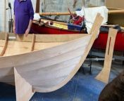 The project to build a skiff in Lydney passed a milestone when the boat was rolled onto a customised stand.