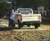 This dude is helping keep a car in place during a competition burnout but slips and his arm slides under the back tire. As the truck pulls away he manages to hold on to what is most important to him.